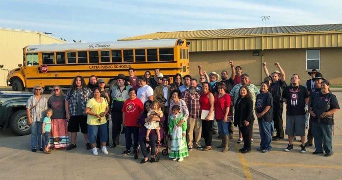 Photo of a large group of people in school parking lot