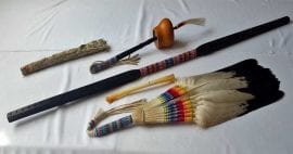 photo of sage, eagle feathers, other objects on table