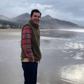 Photo of Caleb Norris on a seashore