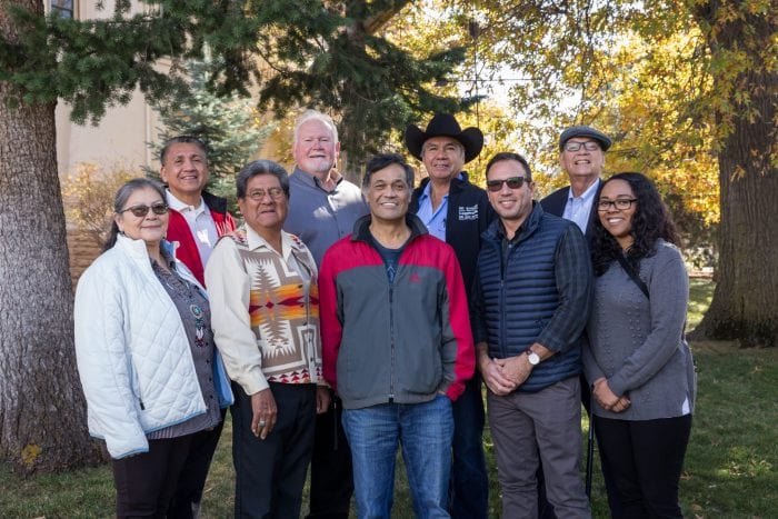 Photo of nine people smiling at the camera