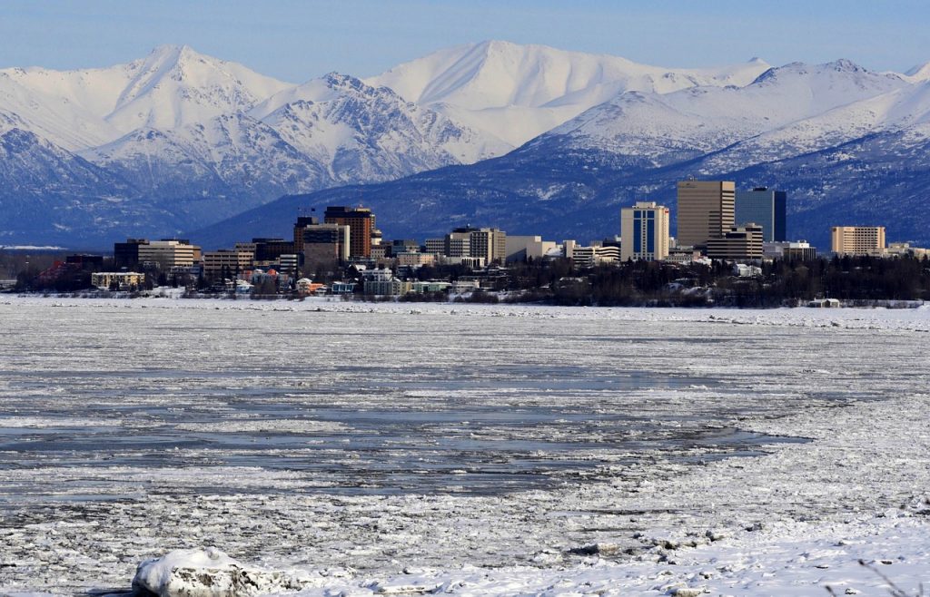 Photo of Anchorage buildings with mountains in the background