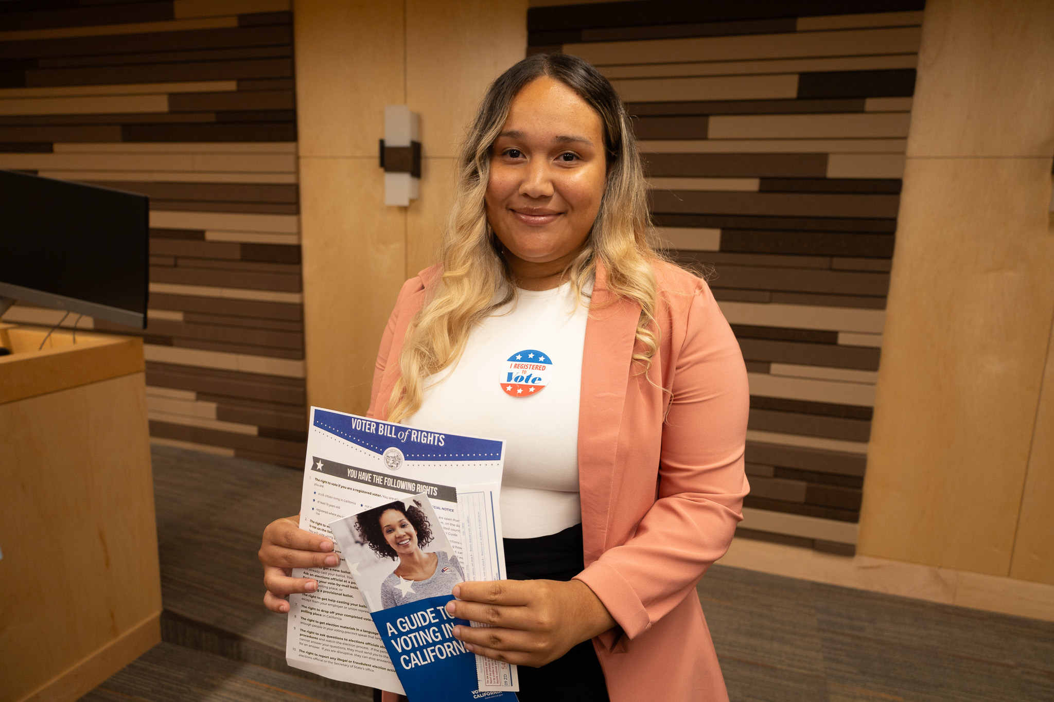 A Shingle Springs Band of Miwok Indians citizen holding up her voter registration materials.